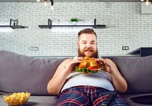 fat man eating sandwich